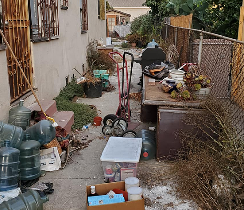residential junk removal job in rialto, ca with trash in yard